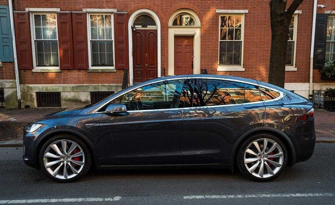 Черный электромобиль Tesla Model уличная парковка
