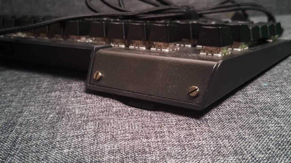 Клавиатура с открученными винтами на серой ткани