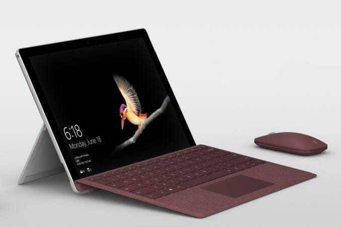 Планшет Surface Go с клавиатурой и мышью на фоне