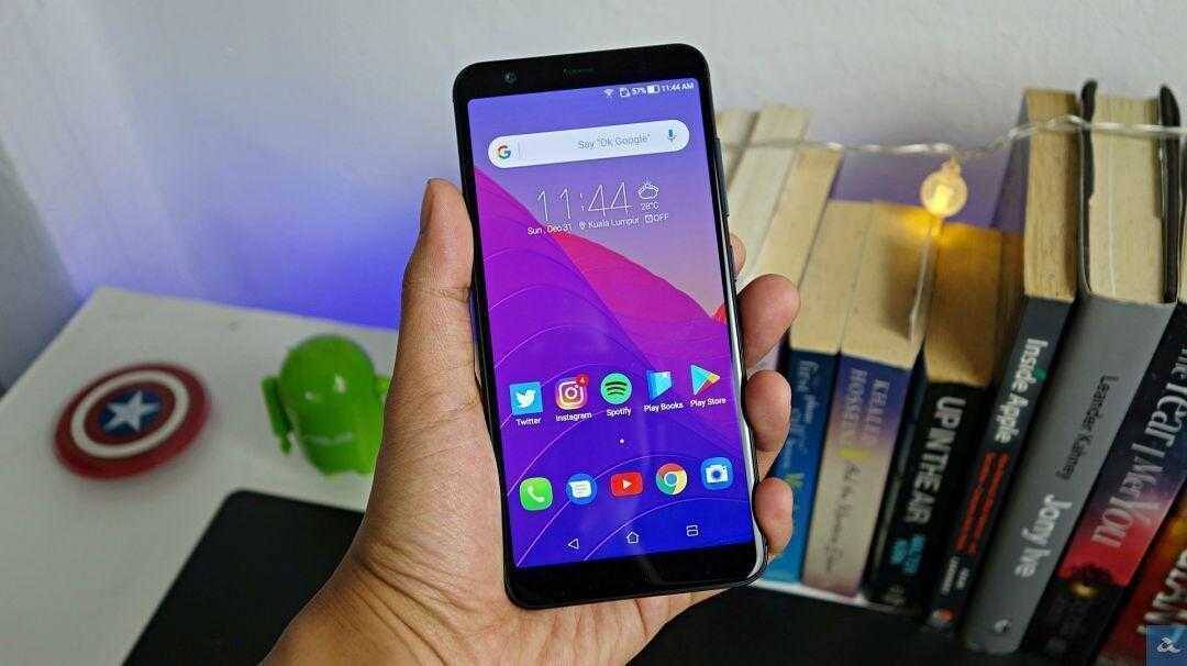 Смартфон Asus Zenfone Max M2 в руке показываемый экран