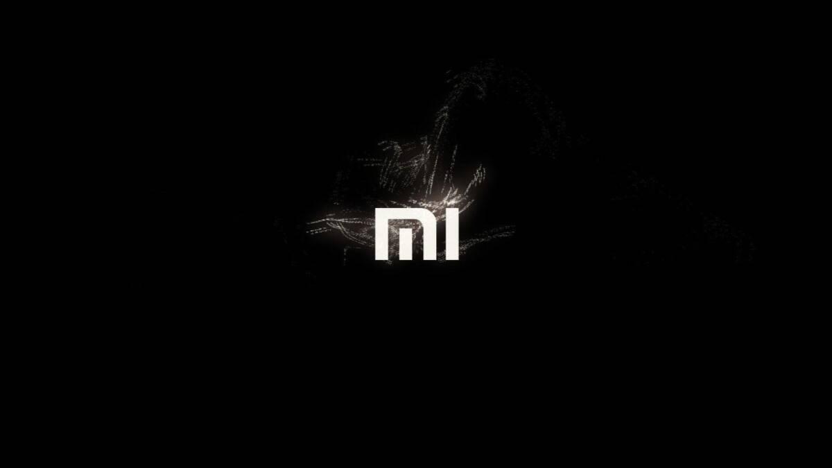 Логотип Xiaomi на черном фоне с эффектами искр и света