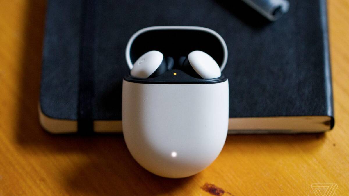 Наушники Google Pixel Buds в открытом кейсе на деревянном столе