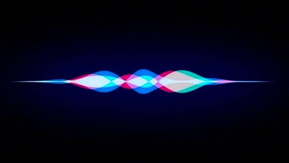 Иконка голосового помощника Siri на темном фоне с цветными волнами