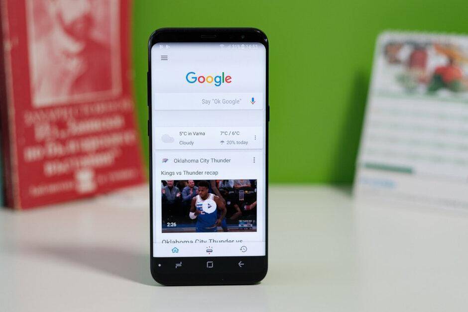 Смартфон Samsung Galaxy S8 отображает приложение Google с темным режимом на экране