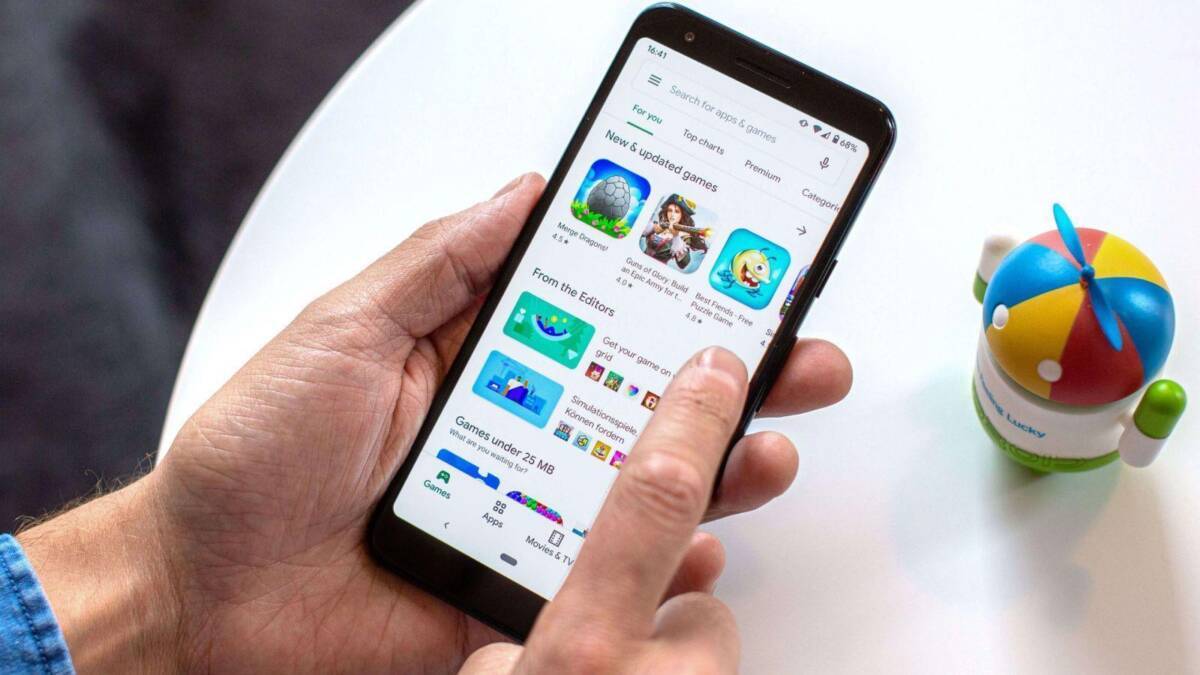 смартфон с открытым магазином Google Play и игрой на экране