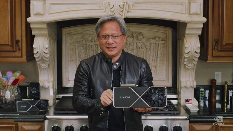 Человек держит графическую карту NVIDIA GeForce RTX 3090 в кухне