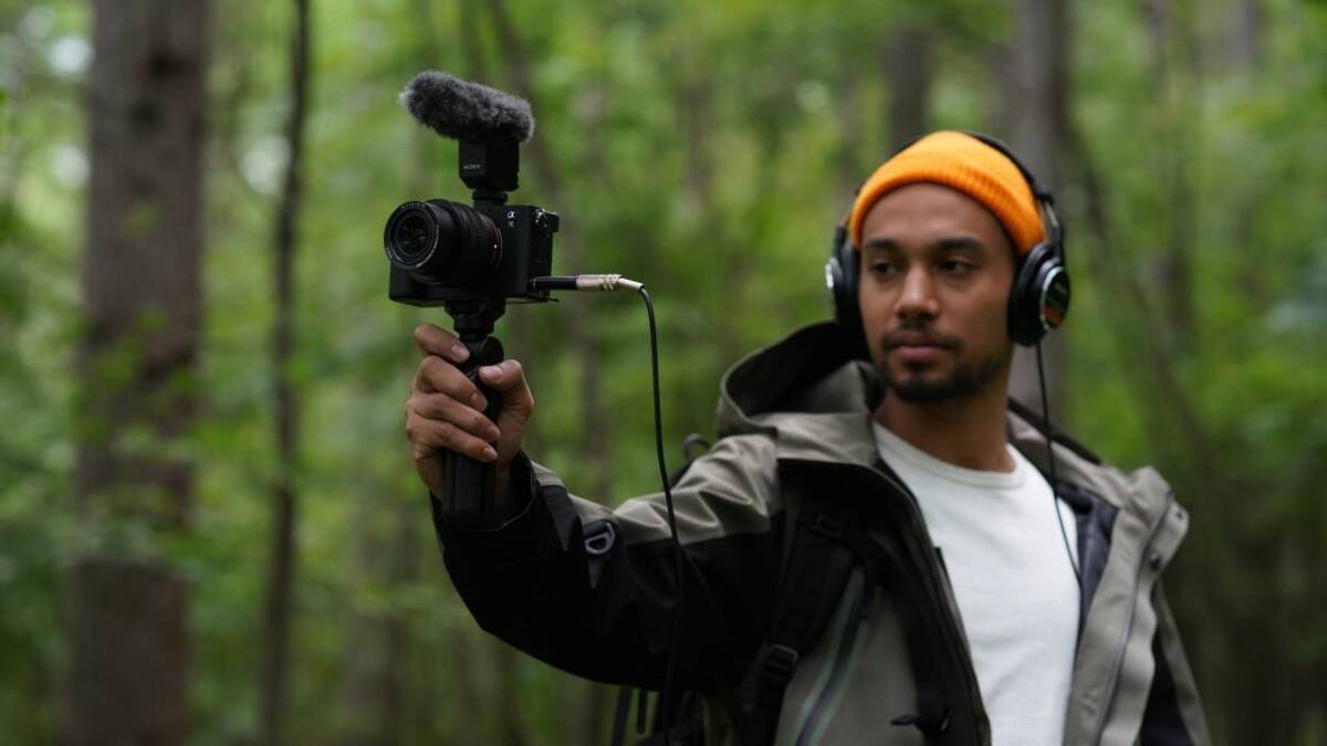 Человек с накамерой Sony Alpha 7C в лесу
