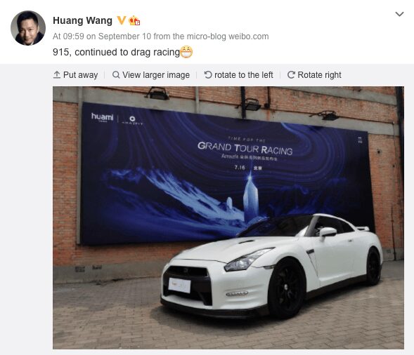 Белый спортивный автомобиль Nissan 370Z на улице у кирпичной стены