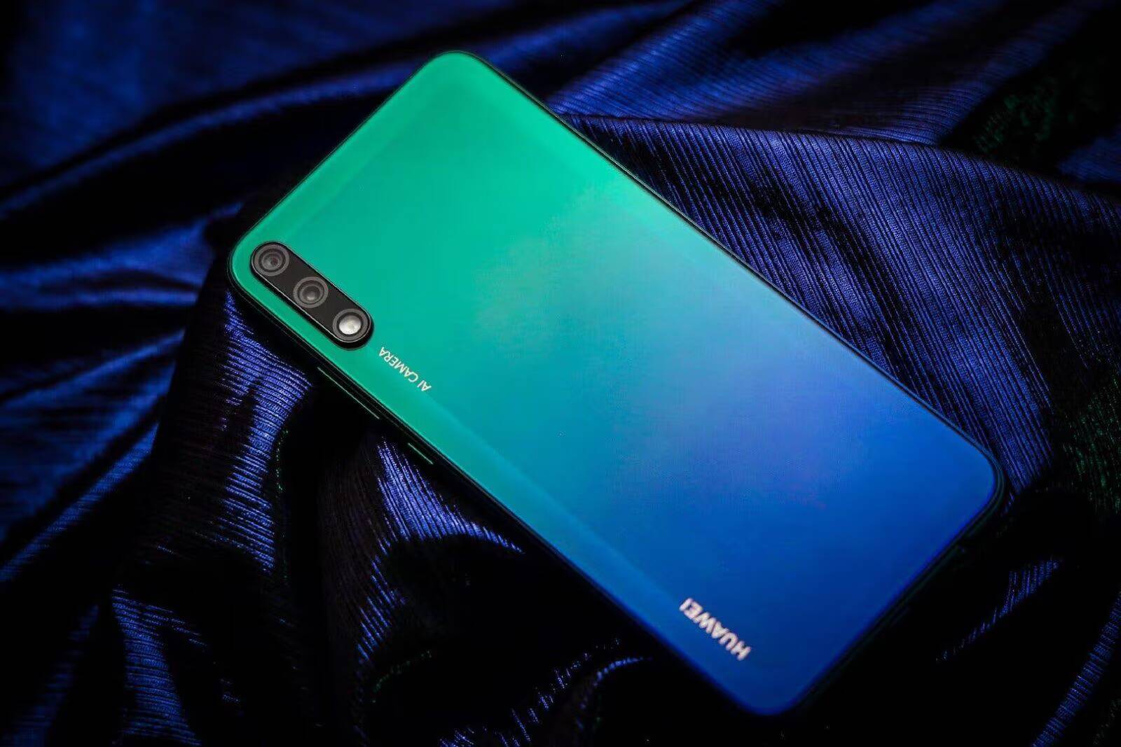 Смартфон Huawei с градиентным синим и зеленым цветом задней панели