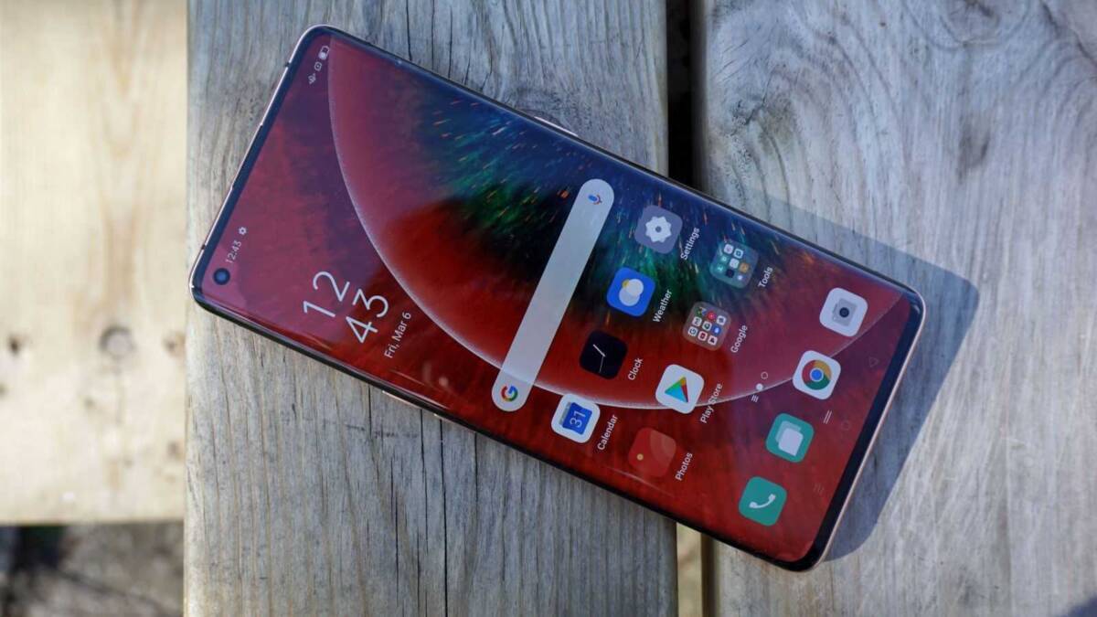 Смартфон OPPO Find X3 Pro на поверхности дерева в профиль