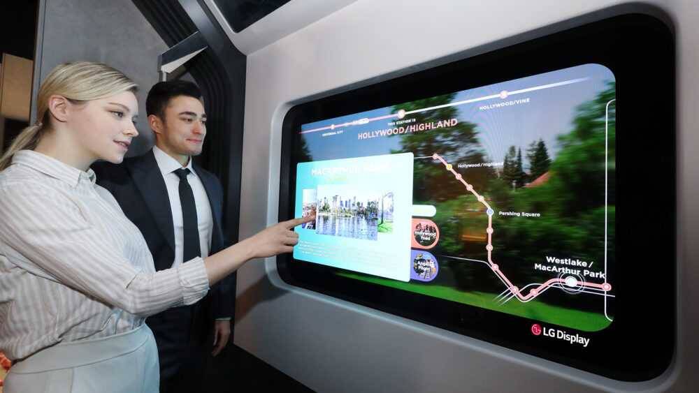 LG представит на CES 2021 прозрачные OLED-панели 4 Две женщины и один мужчина взаимодействуют с прозрачной OLED-панелью LG