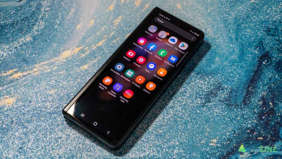 Складной смартфон Samsung Galaxy Z Fold3 на поверхности с песком и водой