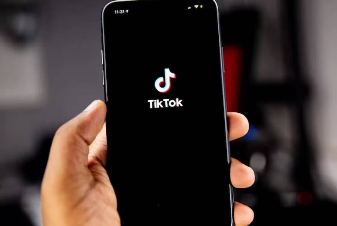 Смартфон с открытым приложением TikTok на экране