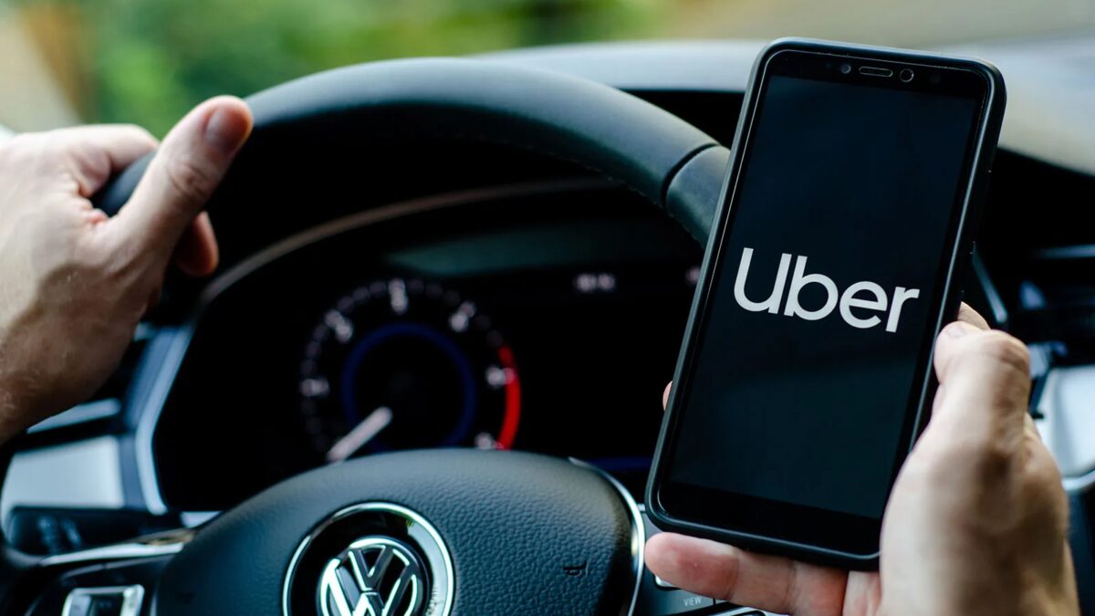 uber driver holds smartphone in car.jpg