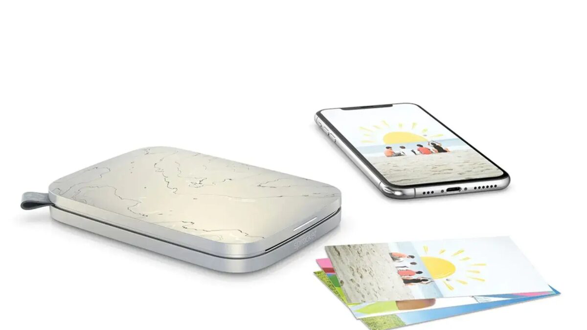 hp sprocket portable shown beside a photo and a phone