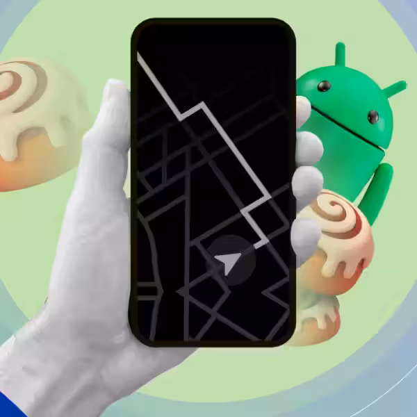 hand holding a phone showing a minimalist map on the always on display with the android mascot and cinnamon rolls in the background