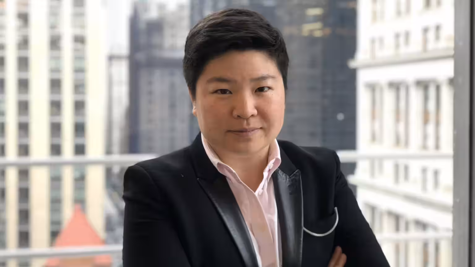 Reddit Jen Wong wearing a black jacket with a light pink shirt