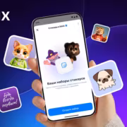 Мобильный телефон с открытым приложением Max и стикерами