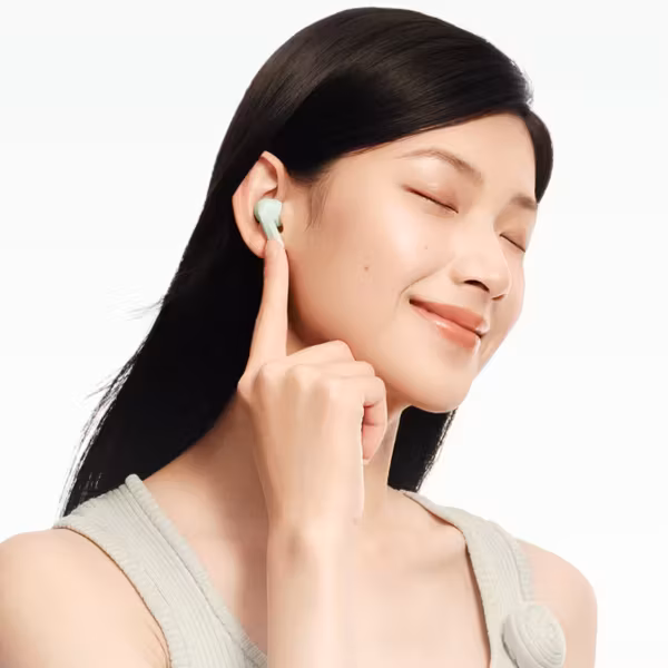 Женщина носит беспроводные наушники Redmi Buds 8 с закрытыми глазами