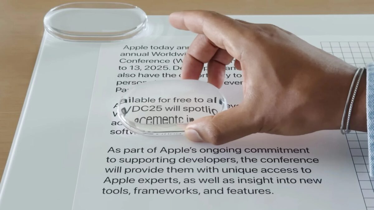 Мужчина держит стеклянную лупу над бумагой с текстом macOS 27 Liquid Glass