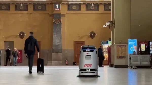 Робот-пылесос PIR в московском вокзале пешеходы с багажом