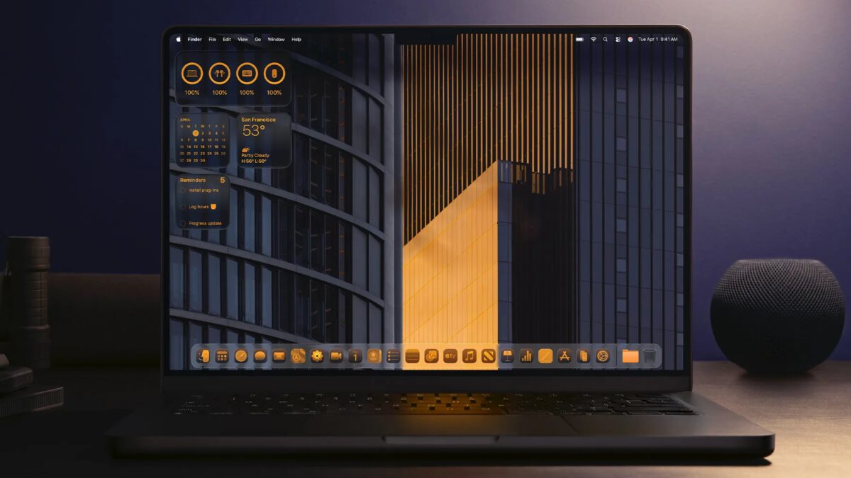 ноутбук с тёмным интерфейсом macOS Liquid Glass