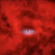 черная дыра вокруг красной точки изображение Уэбб