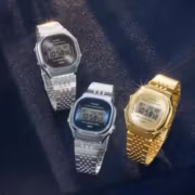 Три цифровых кварцевых часы Casio A140WE в серебристом и золотом цветах на темной ткани