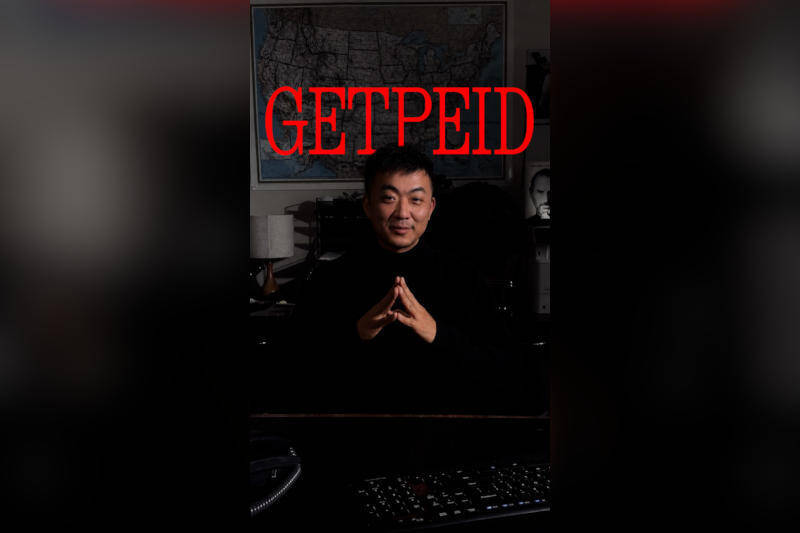 Человек сидит за компьютером с надписью GETPEID