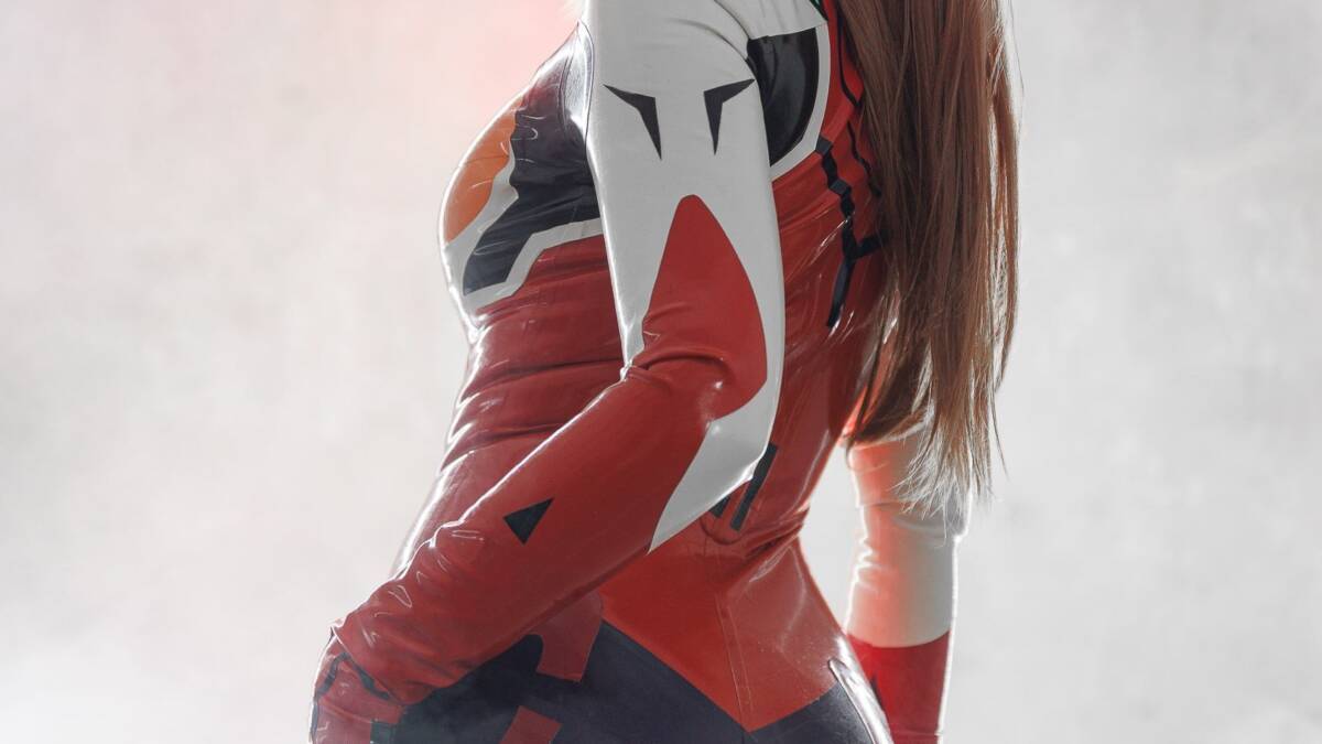 Косплей Аски Лэнгли из аниме Neon Genesis Evangelion на модели с рыжими волосами и костюмом в стиле пилота