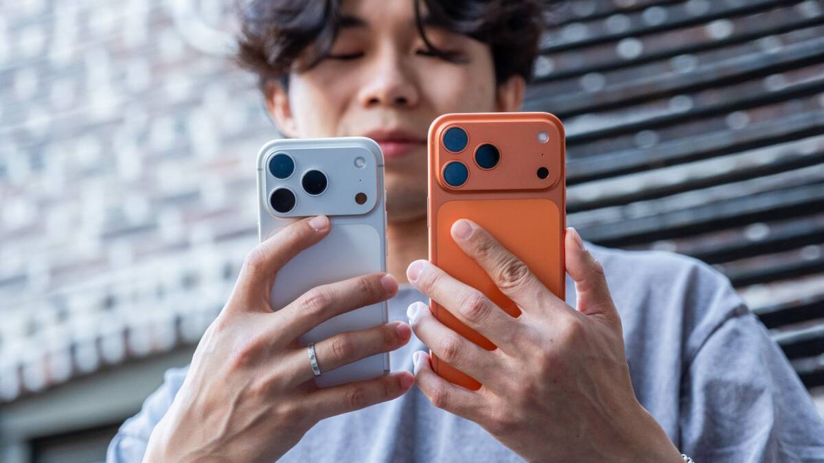 Человек держит два iPhone Apple в руках