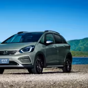 Honda Fit хэтчбек на берегу с горами и озером