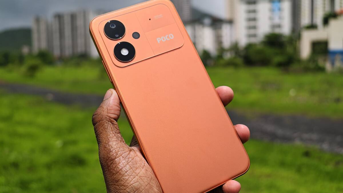 Poco M8 Power показали на видео: три цвета, 8 000 мА·ч и 45 Вт 2 оранжевый смартфон Poco M8 Power на фоне городской среды