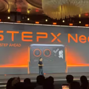 Презентация смартфона StepX Neo на сцене с крупным экраном