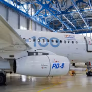 Самолет с маркировкой Ил-114-300 и SJ-100 внутри ангара