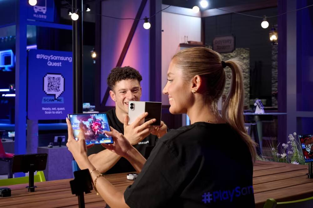 Samsung показала на Gamescom 2026 стенд с 6K-монитором и 3D без очков 2 Два человека используют планшеты и смартфон Samsung на выставке Gamescom 2026