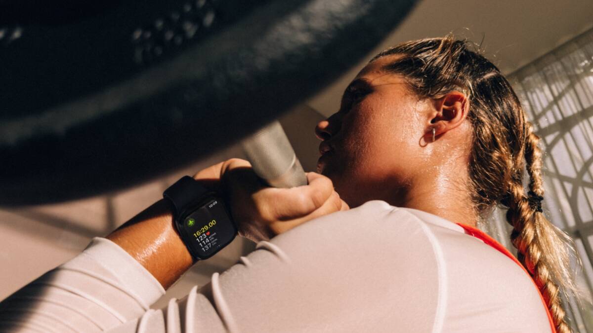 Женщина в спортивной одежде и умных часах Apple Watch Series 12