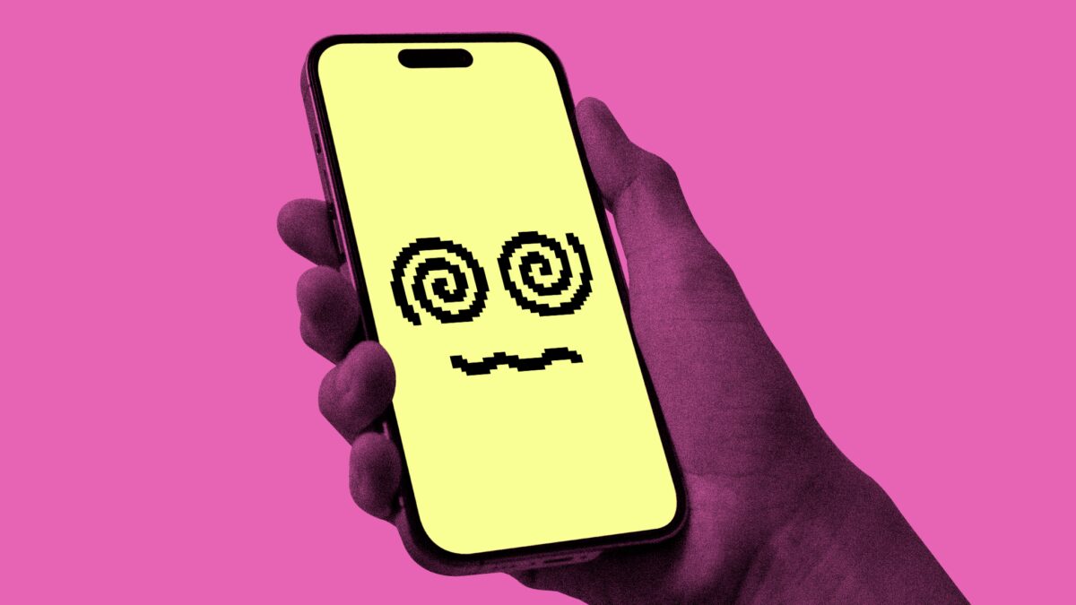 Мобильный телефон с жёлким экраном Character AI на фоне розового цвета