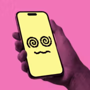 Мобильный телефон с жёлким экраном Character AI на фоне розового цвета